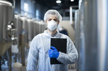 Worker in PPE in beverage processing facility